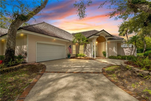 view of front of property with a garage and concrete driveway