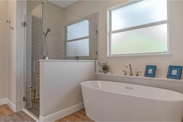 bathroom featuring hardwood / wood-style flooring and independent shower and bath