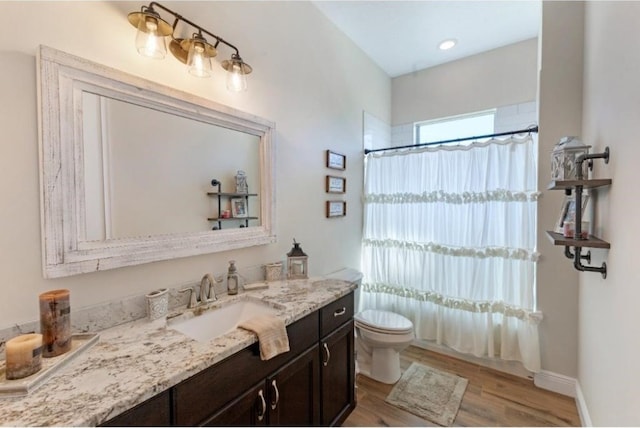 bathroom with vanity, hardwood / wood-style flooring, and toilet