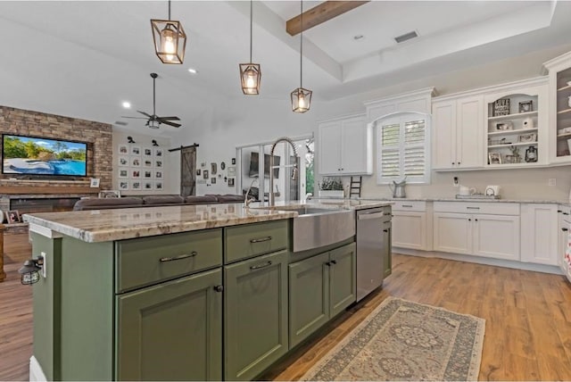 kitchen with white cabinetry, a kitchen island with sink, and stainless steel dishwasher