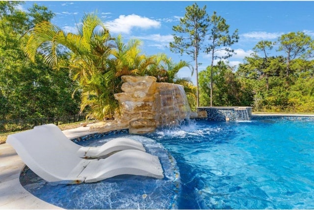 view of swimming pool with pool water feature