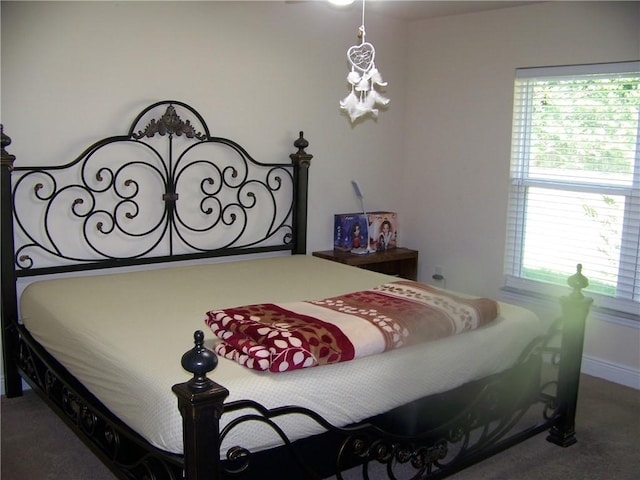 bedroom with carpet flooring and baseboards