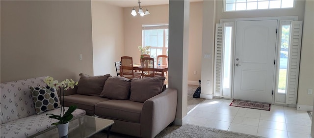 entrance foyer with a chandelier and baseboards