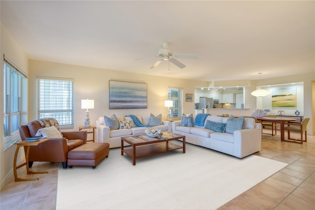 living room featuring light tile patterned floors and ceiling fan