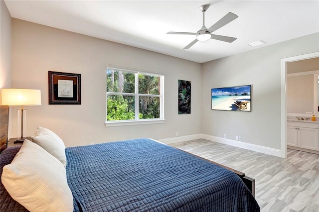710 Canoe Trl, Vero Beach, FL 32963 - bedroom with light wood finished floors, baseboards, ensuite bathroom, and ceiling fan