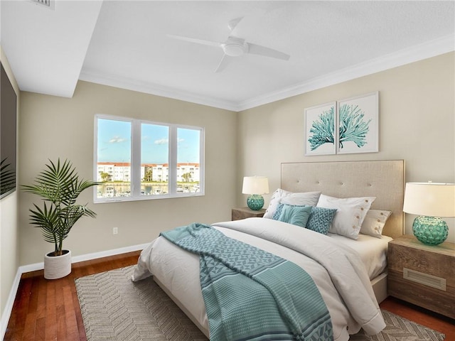 bedroom with ceiling fan, dark hardwood / wood-style floors, and ornamental molding