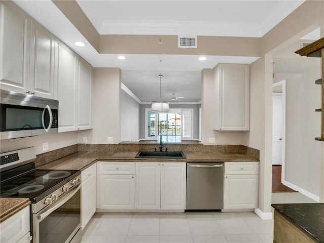 kitchen with sink, ceiling fan, light tile patterned floors, white cabinetry, and stainless steel appliances