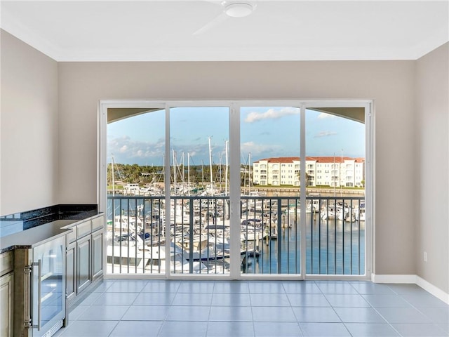 interior space with a water view, beverage cooler, and ceiling fan