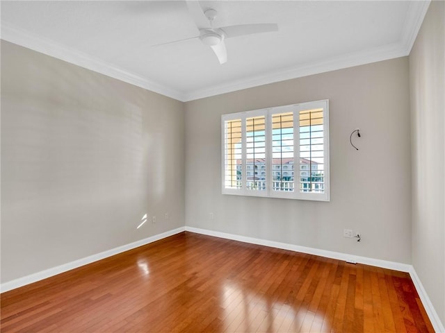 empty room featuring hardwood / wood-style floors, ceiling fan, and crown molding