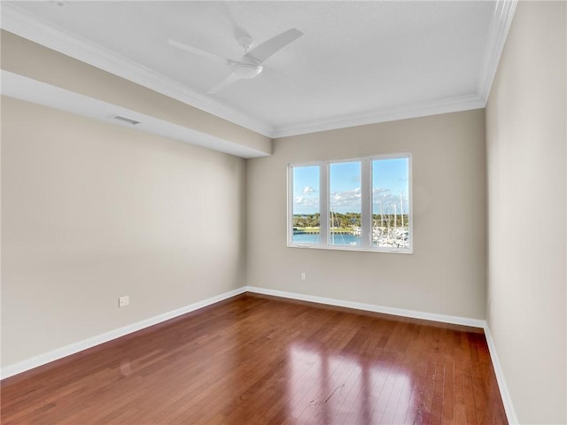 spare room featuring ceiling fan, hardwood / wood-style floors, and crown molding