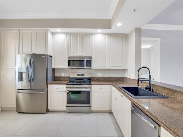 kitchen with white cabinetry, sink, stainless steel appliances, light tile patterned floors, and ornamental molding