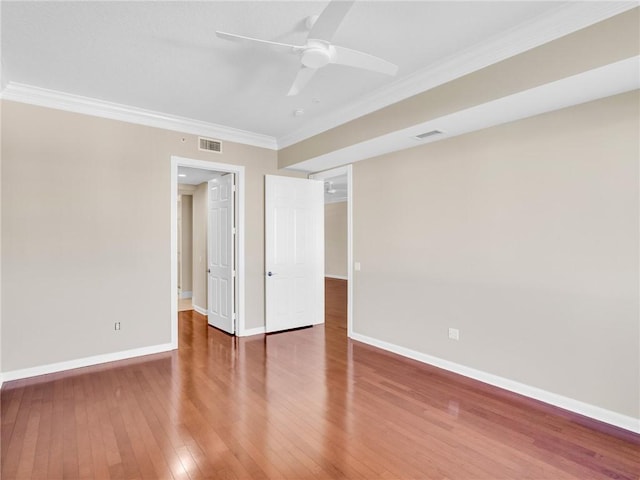 unfurnished room featuring wood-type flooring, ceiling fan, and ornamental molding