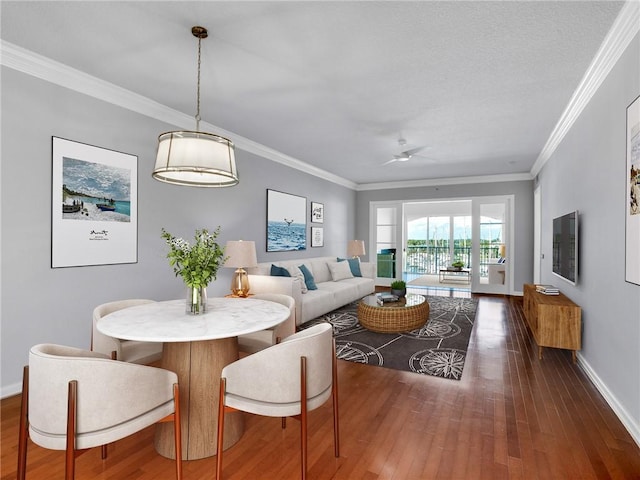 dining area featuring dark hardwood / wood-style flooring and crown molding