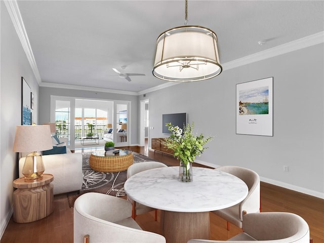 dining area featuring ceiling fan, dark hardwood / wood-style floors, and ornamental molding