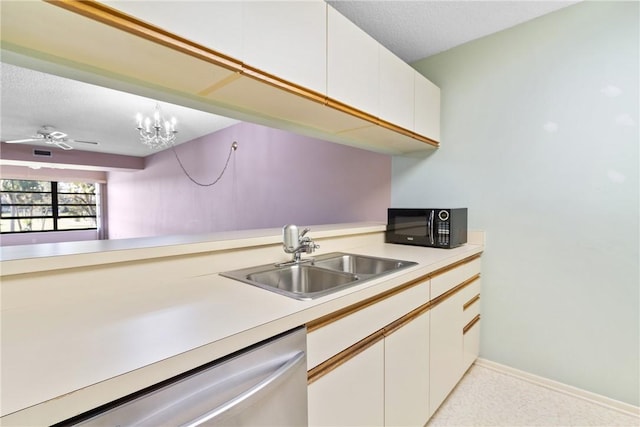 kitchen with sink, stainless steel dishwasher, decorative light fixtures, white cabinets, and ceiling fan with notable chandelier