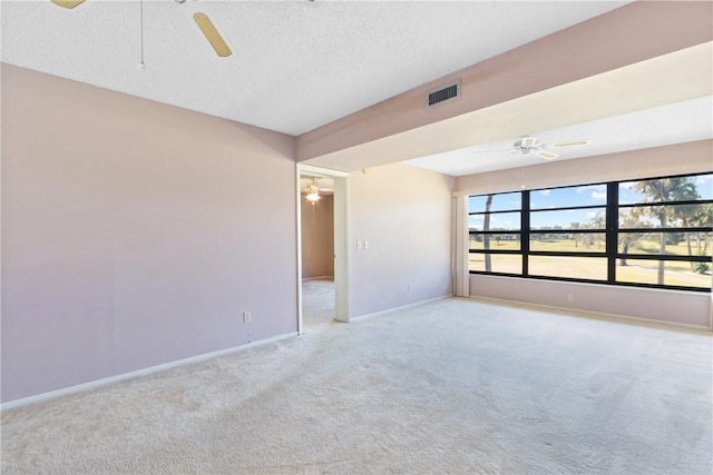 carpeted spare room with a textured ceiling