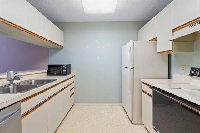 kitchen with white cabinets, white appliances, and sink