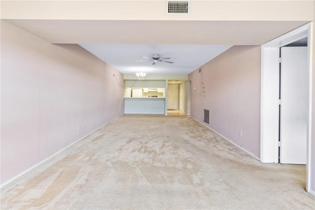 unfurnished living room with ceiling fan and light colored carpet