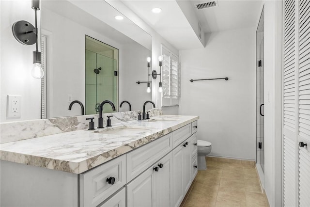 bathroom featuring toilet, tile patterned flooring, and vanity