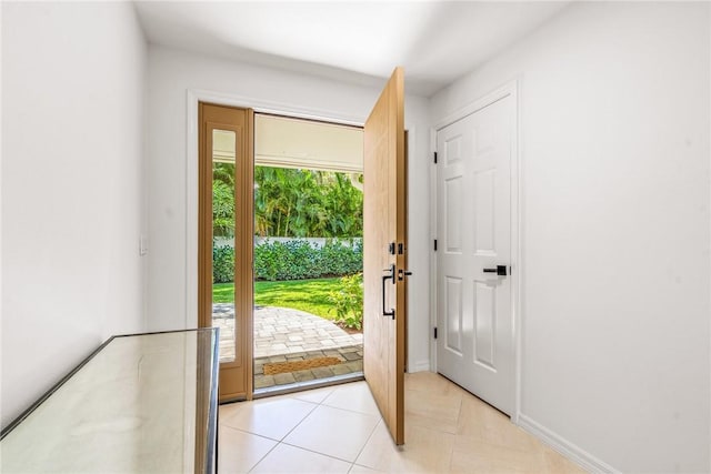 entryway with light tile patterned flooring