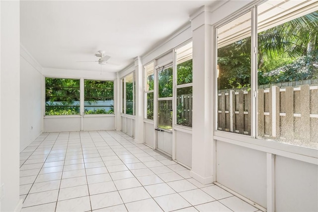 unfurnished sunroom with ceiling fan