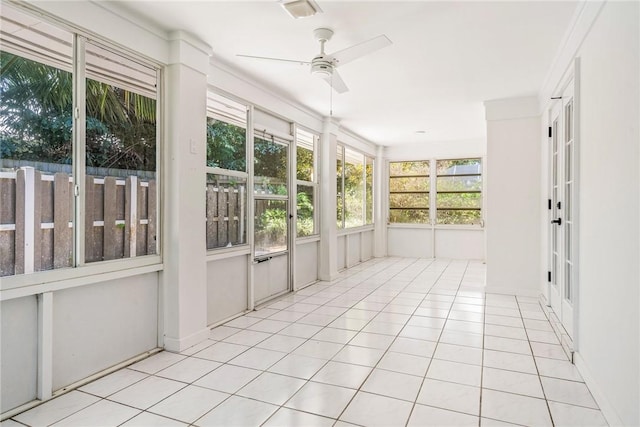 unfurnished sunroom featuring ceiling fan