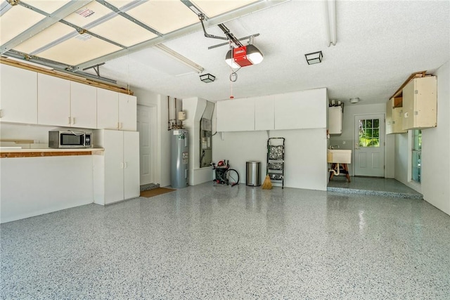 garage with electric water heater, water heater, sink, and a garage door opener