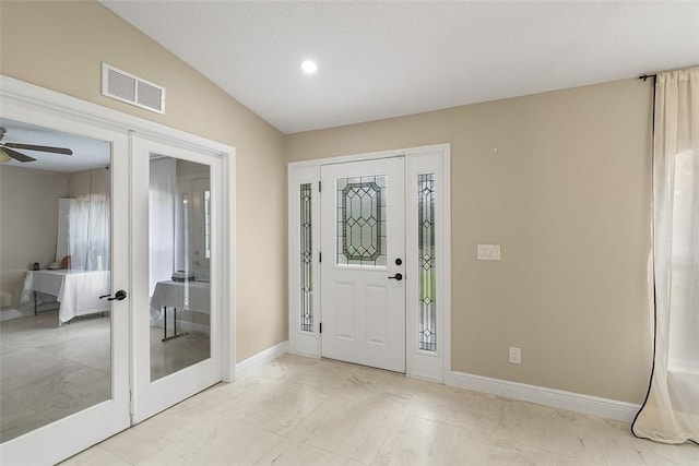 entrance foyer with a ceiling fan, french doors, visible vents, and baseboards