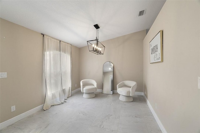 unfurnished room with marble finish floor, visible vents, and baseboards