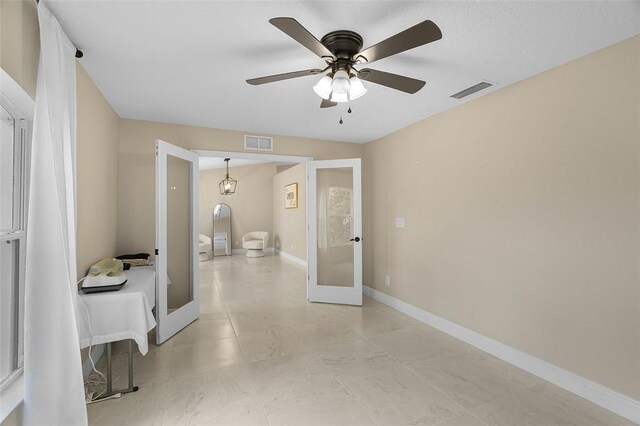 interior space featuring baseboards, visible vents, and french doors