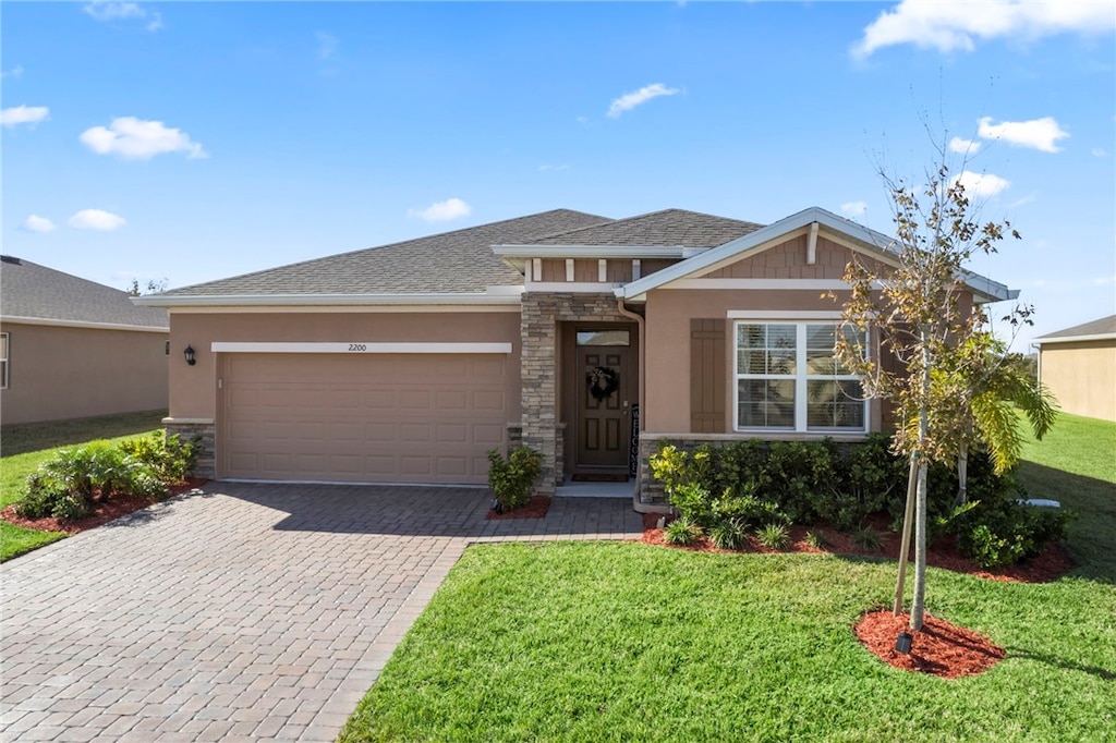 view of front of house with a garage and a front lawn