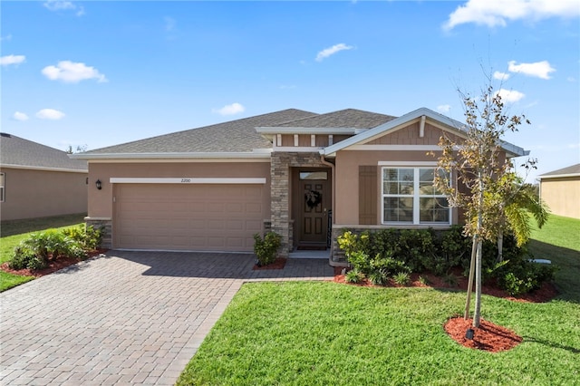 view of front of house with a garage and a front lawn