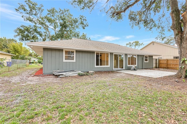 back of property featuring a lawn and a patio