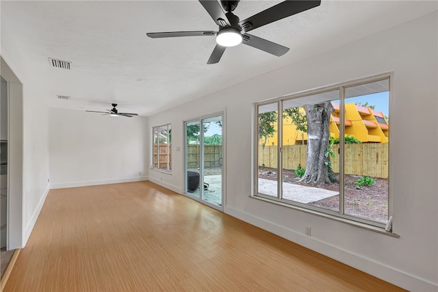 spare room with light hardwood / wood-style floors and ceiling fan