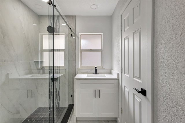 bathroom featuring vanity and a shower with door