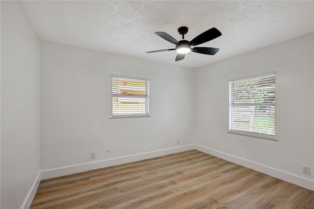 spare room with ceiling fan, a textured ceiling, and light hardwood / wood-style flooring