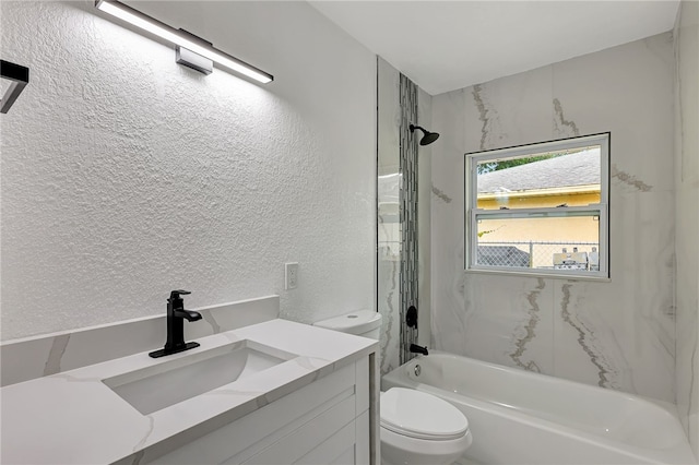 full bathroom with vanity, tiled shower / bath combo, and toilet