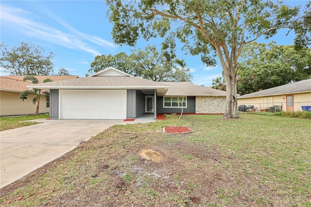 single story home with a front yard and a garage