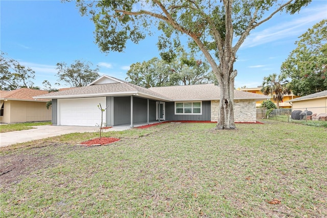 ranch-style home featuring a garage and a front lawn