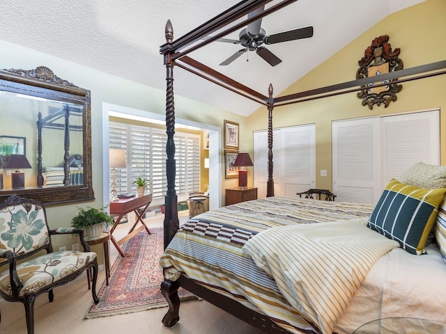 bedroom featuring lofted ceiling, carpet floors, a textured ceiling, and ceiling fan