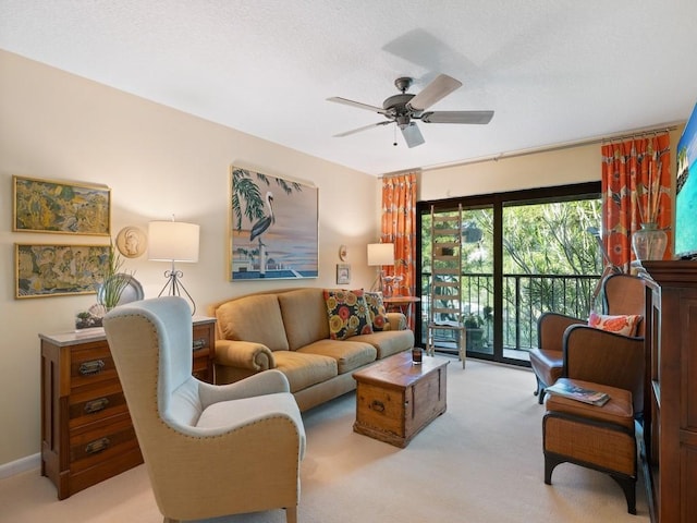 carpeted living room featuring ceiling fan