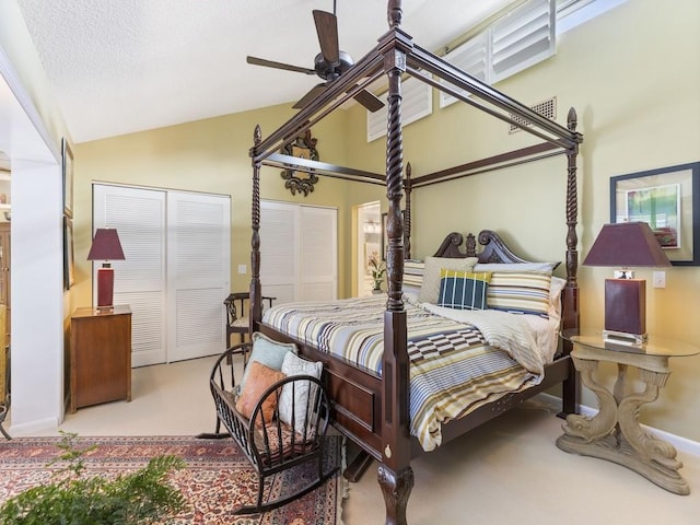 bedroom featuring lofted ceiling, light carpet, and a textured ceiling