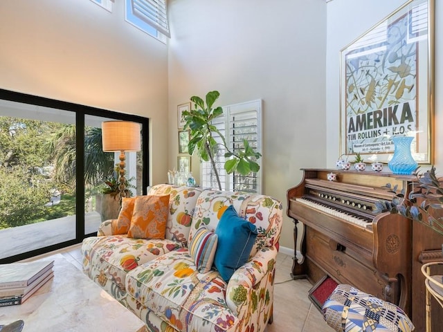 living area with a high ceiling and tile patterned floors