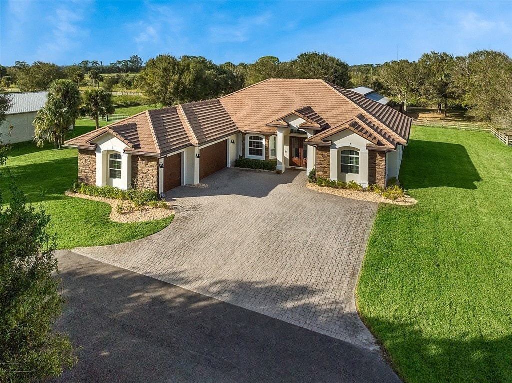 single story home with a front yard and a garage