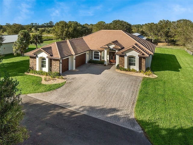 single story home with a front yard and a garage