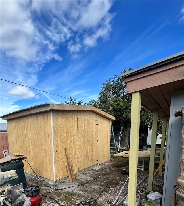 view of side of home with a storage shed