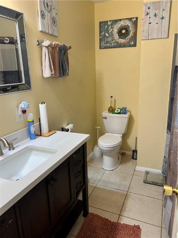 bathroom featuring tile patterned floors, vanity, and toilet