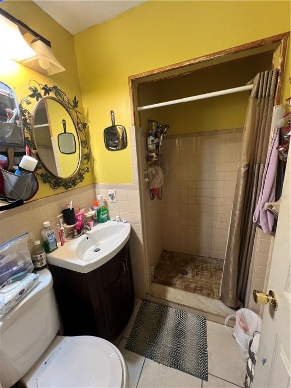 bathroom with a shower with shower curtain, tile patterned flooring, toilet, and tile walls