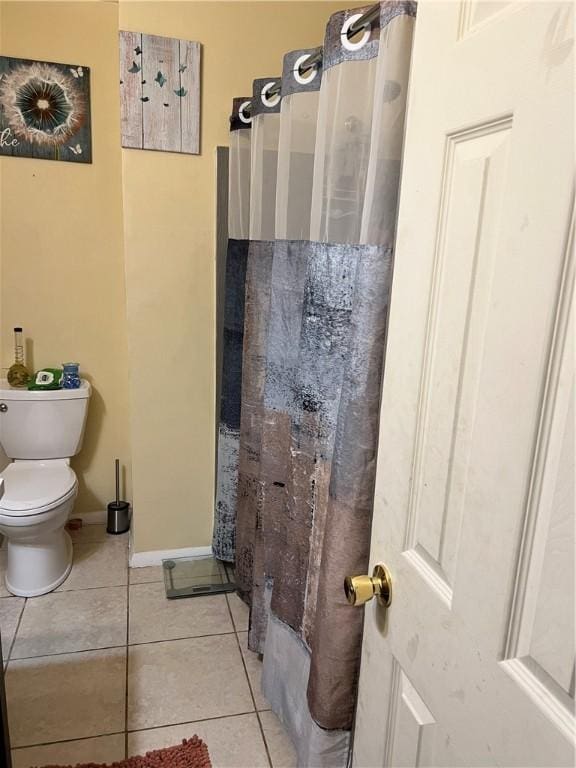 bathroom featuring toilet and tile patterned floors