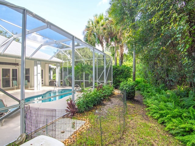 view of pool with a lanai and a patio area